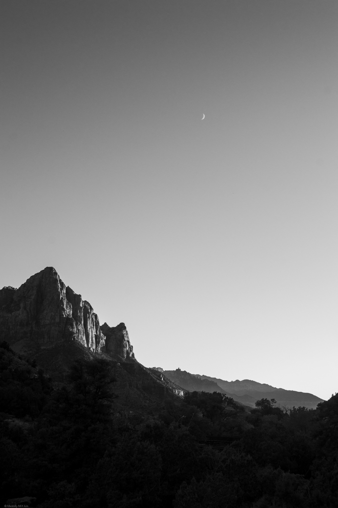 A black and white portrait of the Watchman and a crescent moon