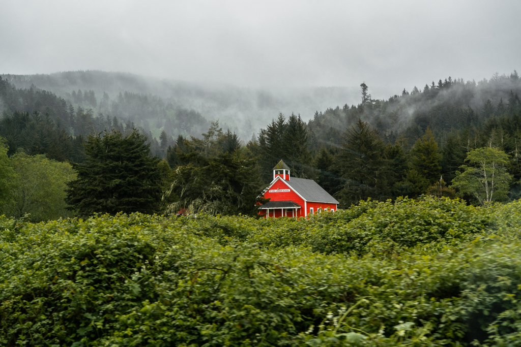 A red school house in the mist