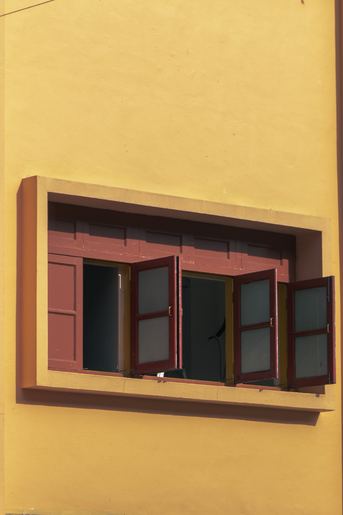 The yellow walls with simple wooden shutters was really nice