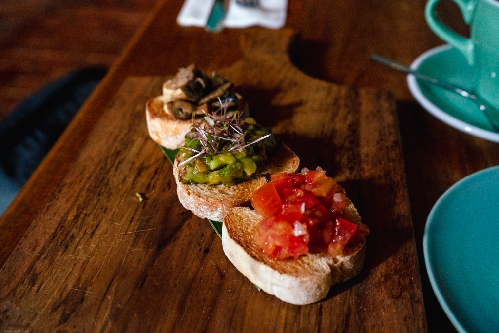 A board with small toast snacks