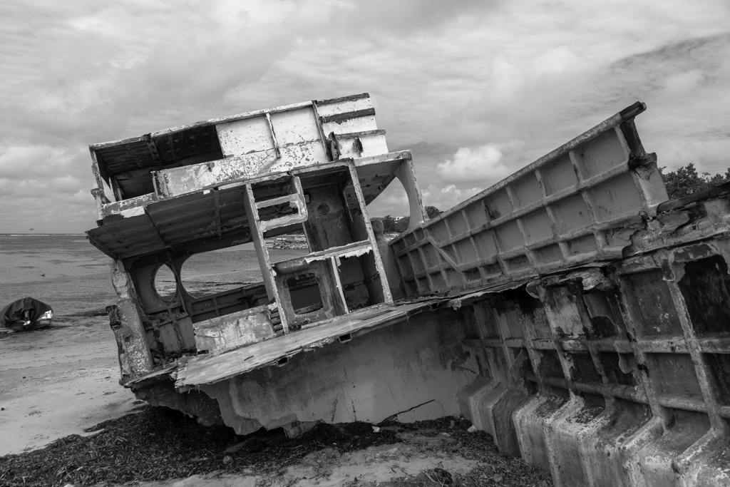 A rusty and abandoned boat on the beach