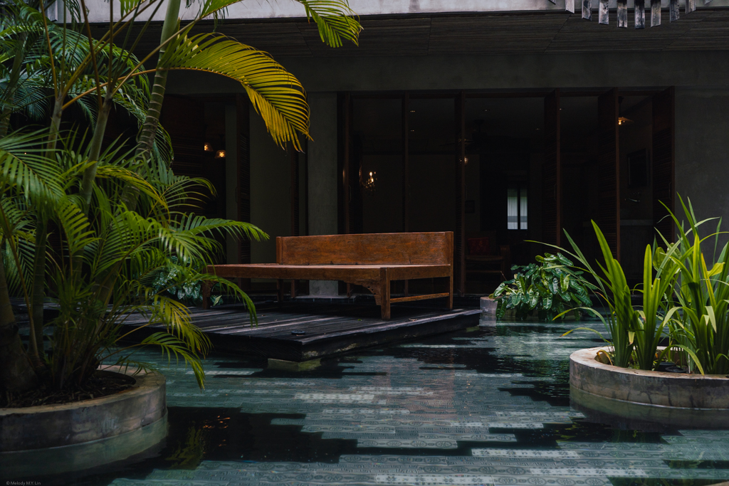 A long wooden bed in the middle of a pool