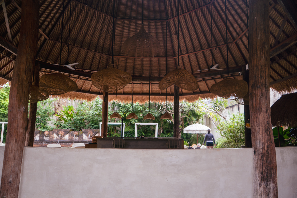 Pool cabana with woven lamps