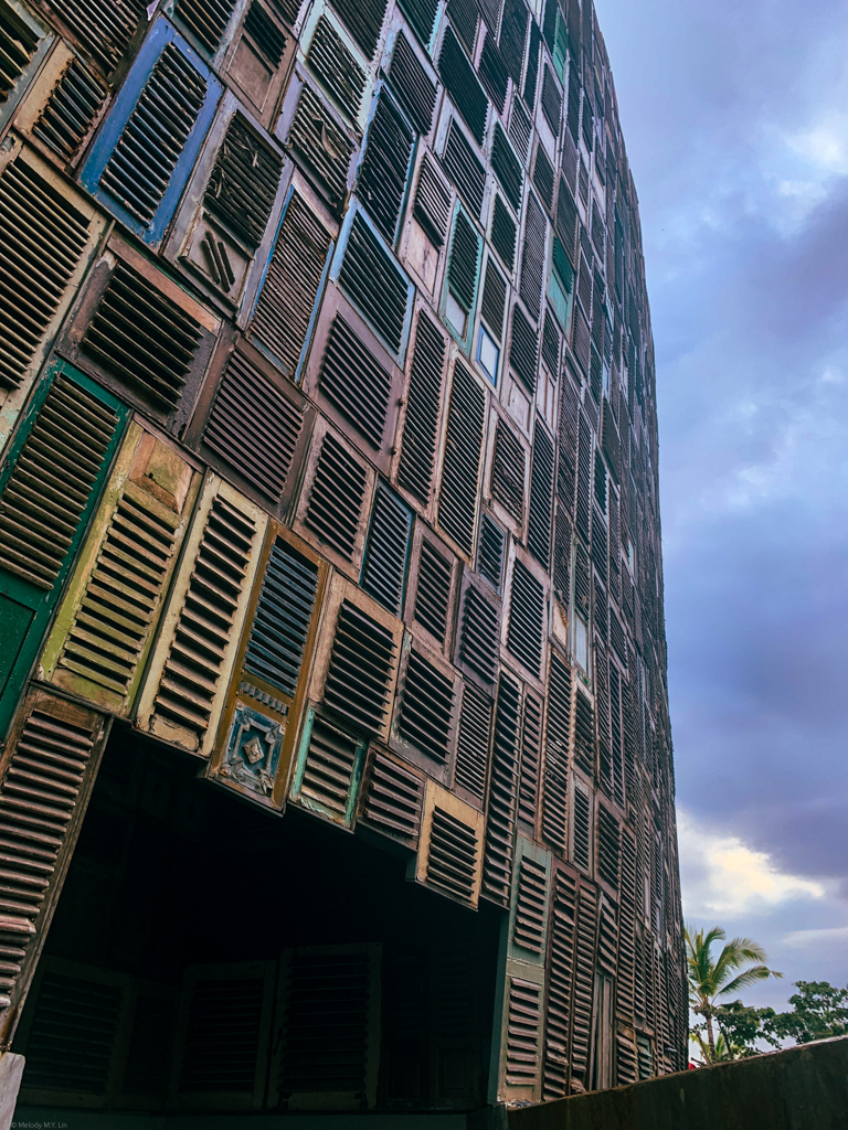 A matrix of wooden shutters on the outside walls of the club