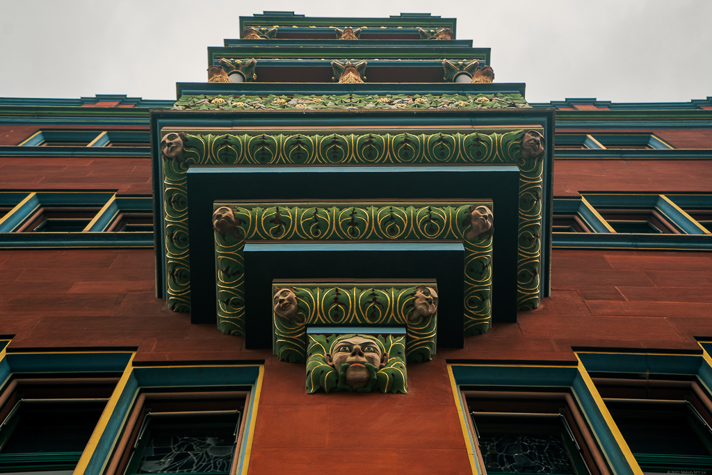 A wooden fractal coming out of the bottom of a balcony