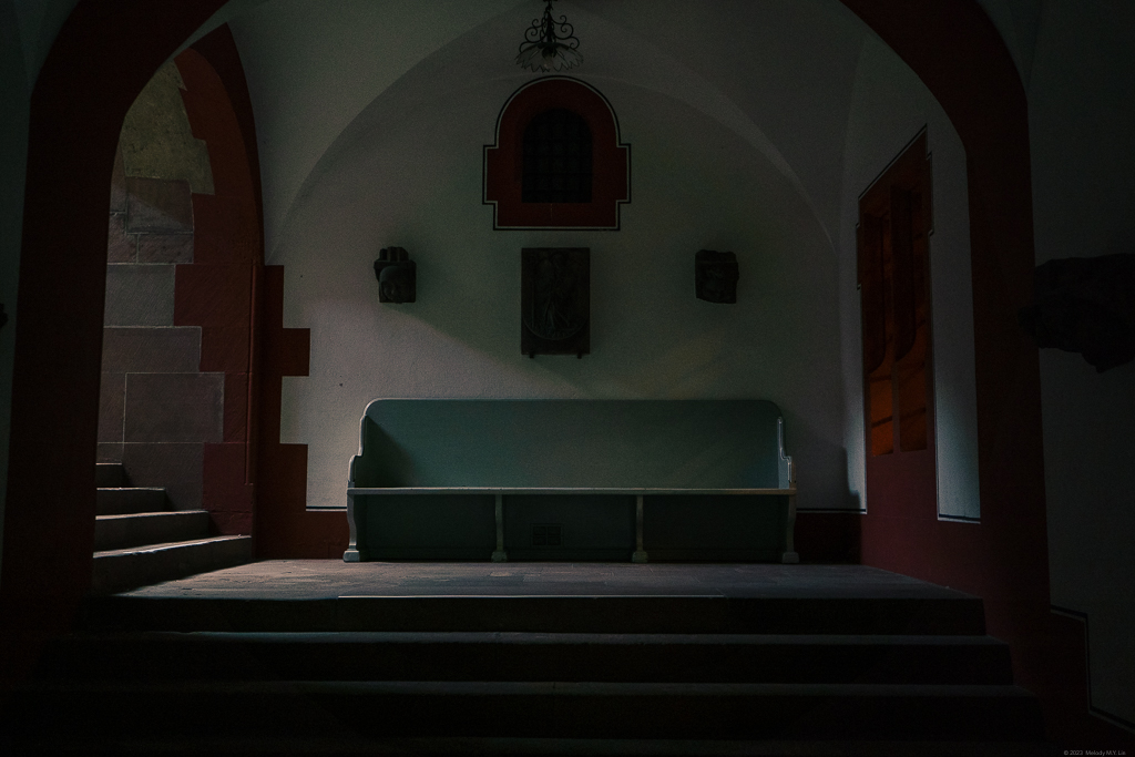 A still of a bench at the foot of the stairs