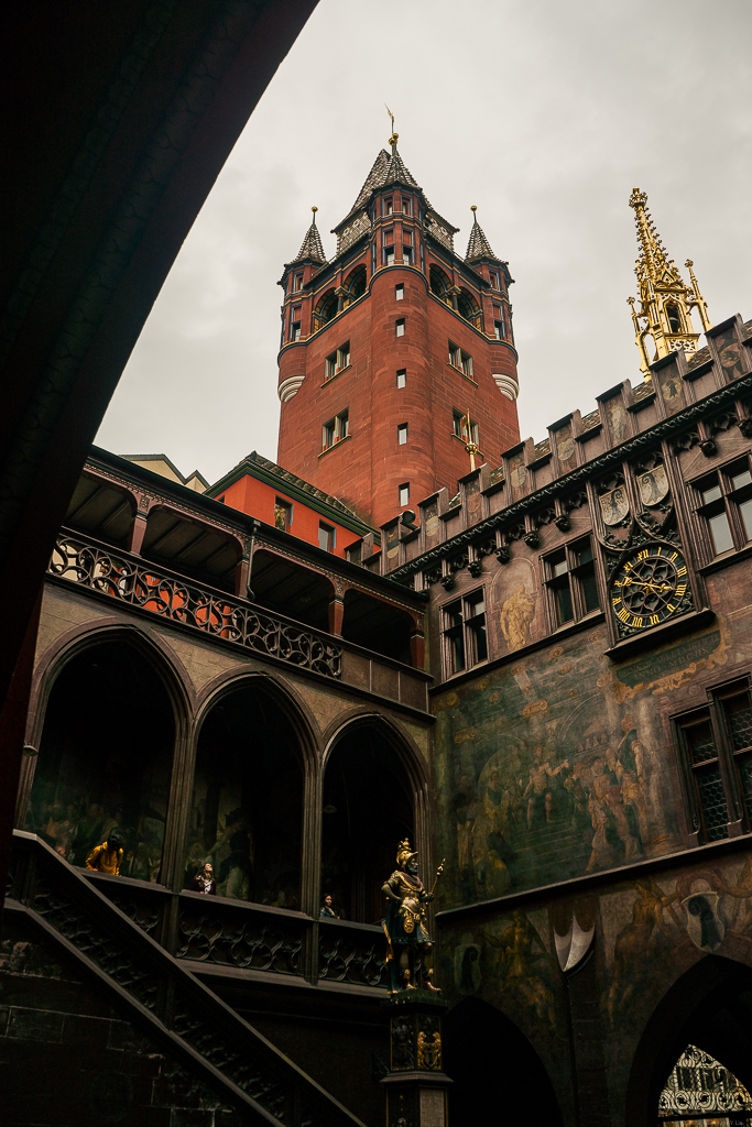 Looking up at the red sandstone tower and golden minaret of the Rathaus