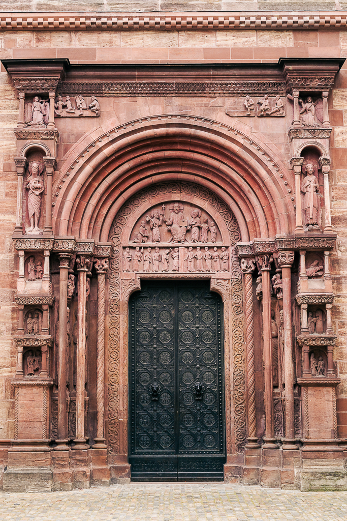 Religious figures carved into the red sandstone doors