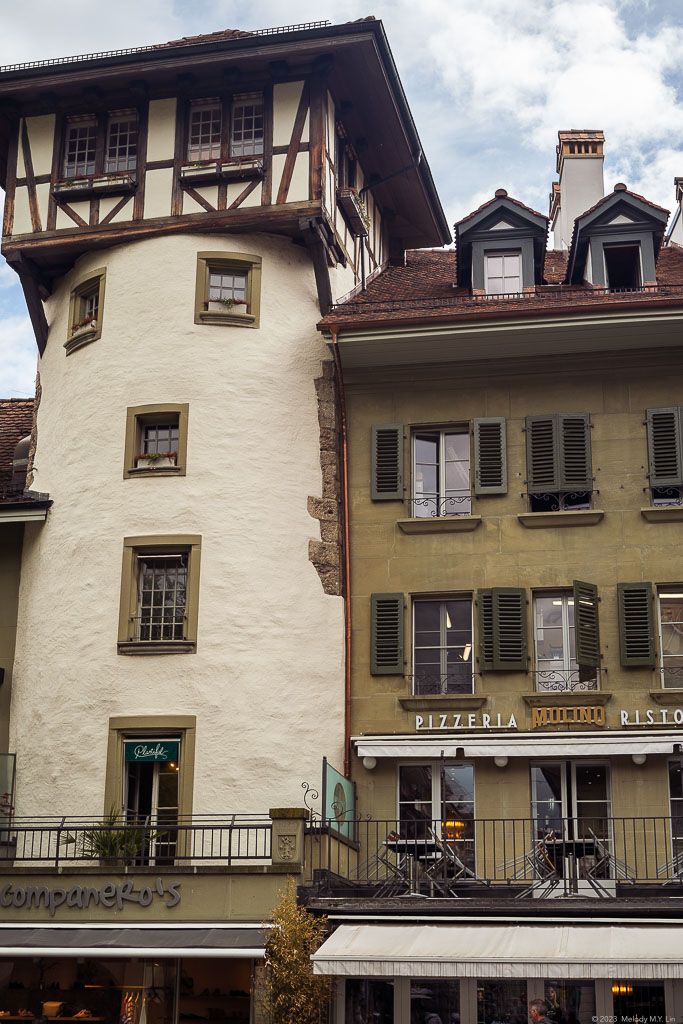 A medieval tower with restaurants on the bottom