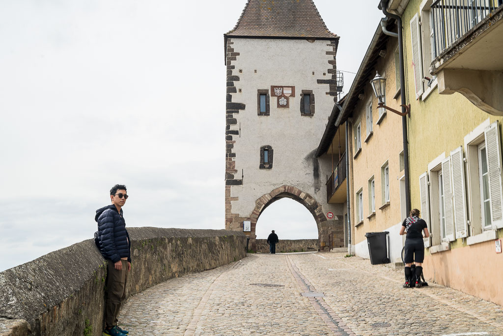 D standing in from of the gate to the cathedral.