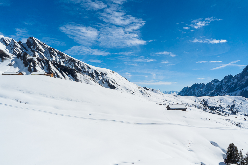 A snowy plateau where you can see deep into the mountain range