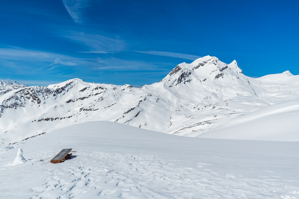 A bench overlooking the surrounding mountains