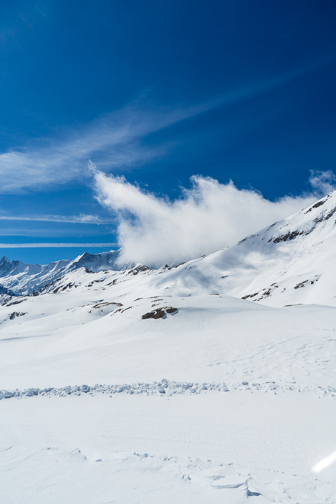 Color photo of clouds rising over the ridge