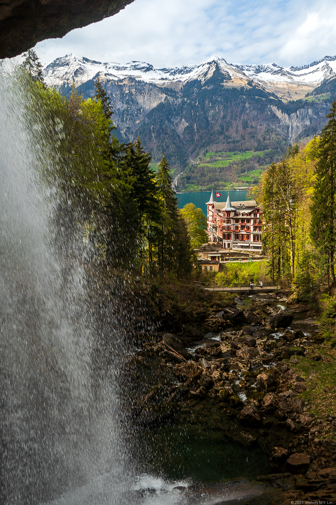 View from waterfall with hotel and mountains in backdrop
