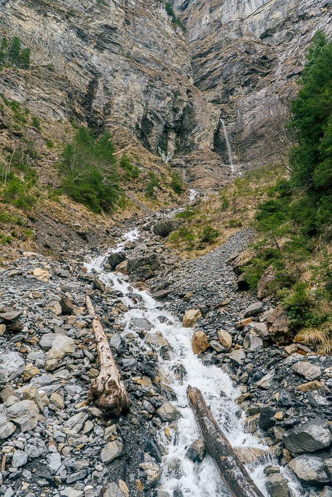 Standing at the bottom of a fast-flowing creek coming down the mountainside