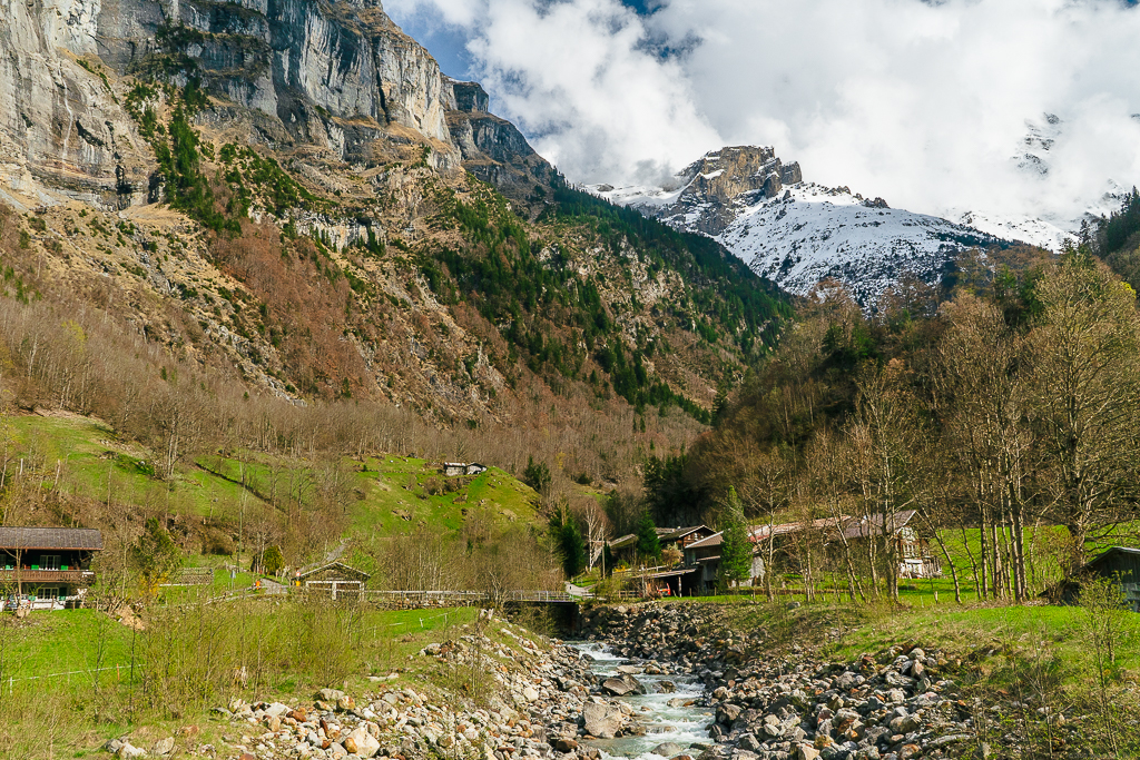 Landscape view of a stream crossing and Alps in the background