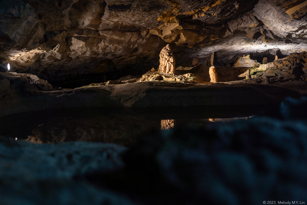 A large stalagmite almost touches the ceiling