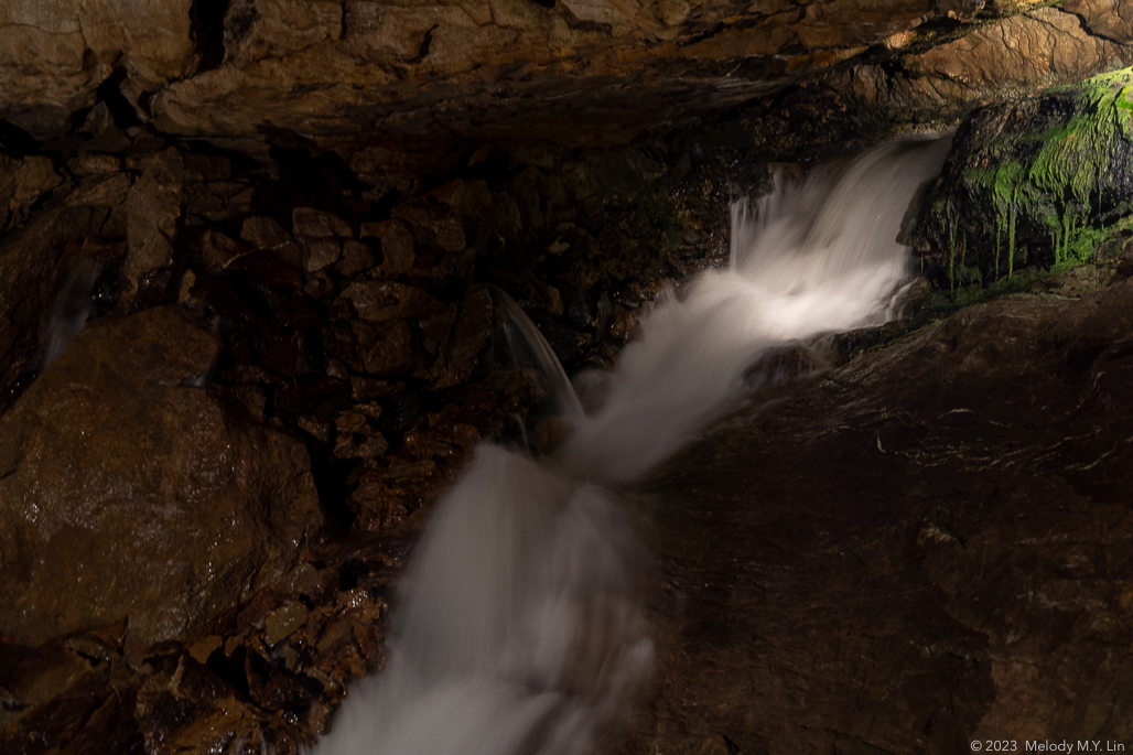 A fast-flowing stream running through the cave