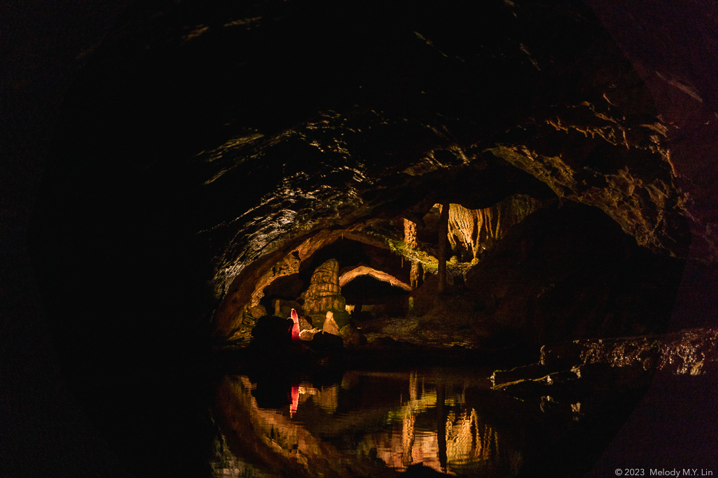 A reflection of a chamber with stalagmites