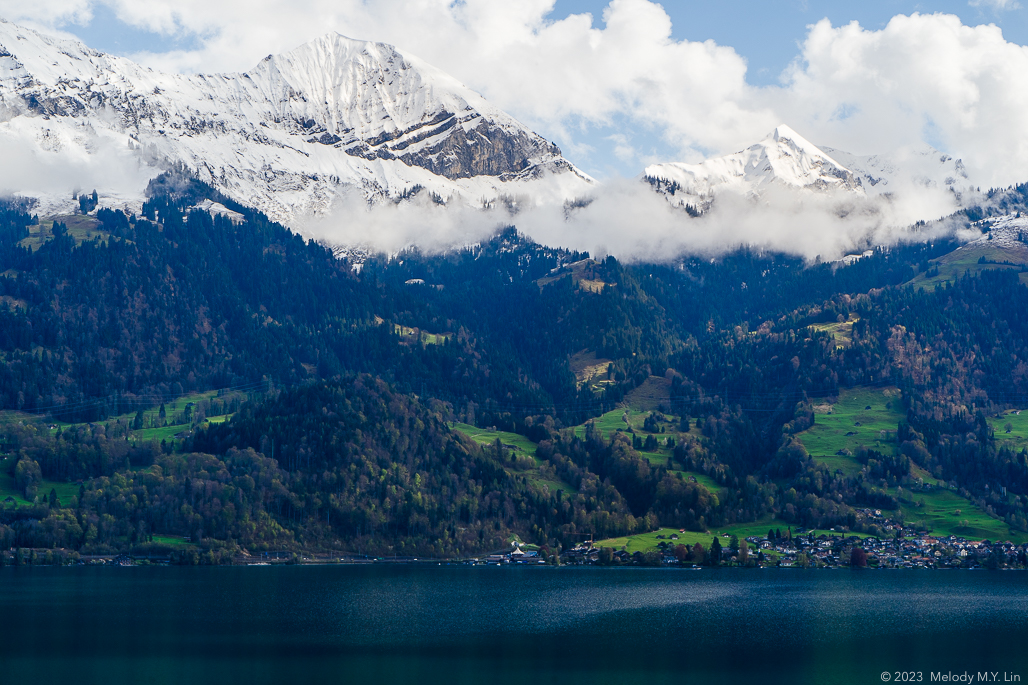 A ribbon of clouds rest just below the mountain peaks