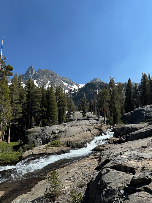 A waterfall cascades down granite slopes