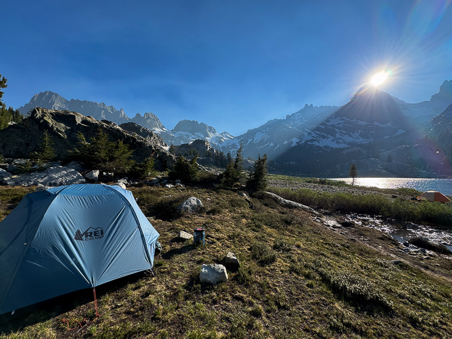 The sun setting behind the peak with our tent in the foreground.